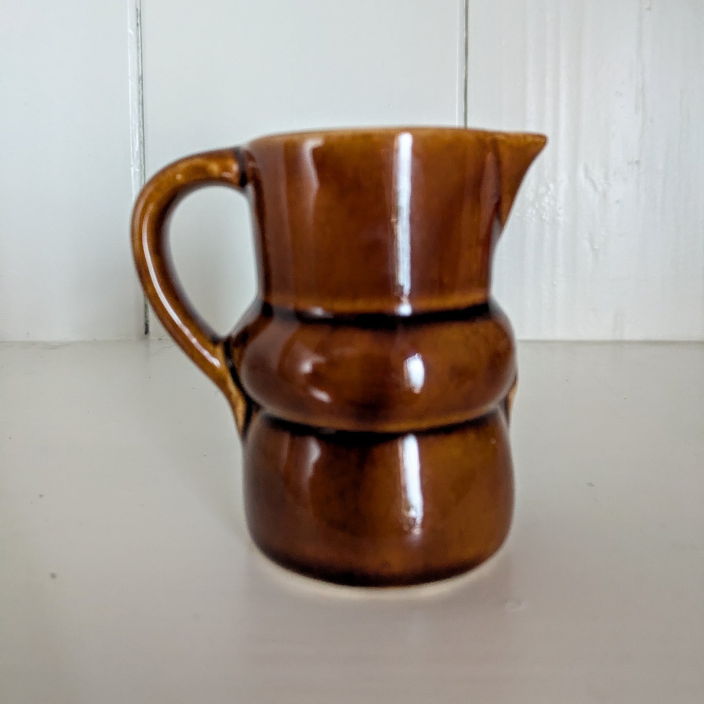 Dachshund Sausage Dog Milk Jug "Making Both Ends Meet" in a Dark Brown Glaze